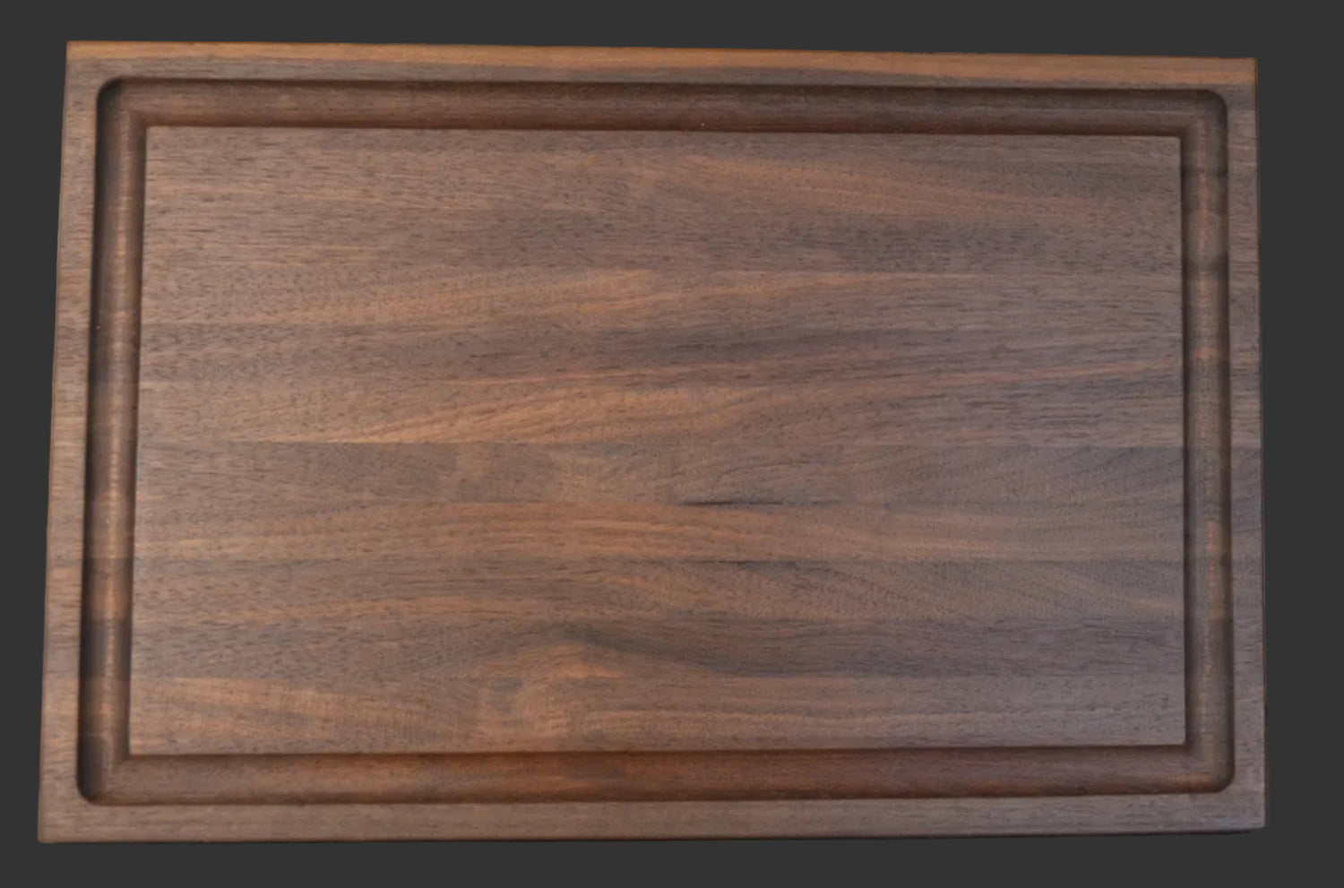 A medium size, Black Walnut cutting board with a juice groove. 
